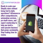 A close-up of hands holding a smartphone displaying the Shopify logo, with a laptop and a cup of coffee in the background, suggesting a flexible work environment. Text explains how AICommerce helps scale Shopify stores with automation, pre-built stores, and mentorship for a semi-passive business.